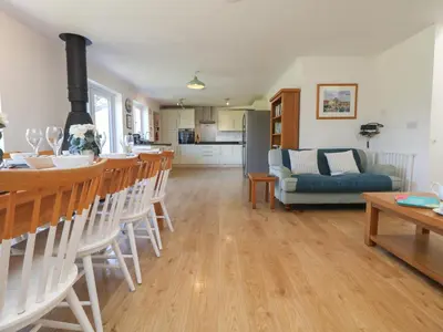 a living room with a kitchen and a dining room at Penhaven in Bude