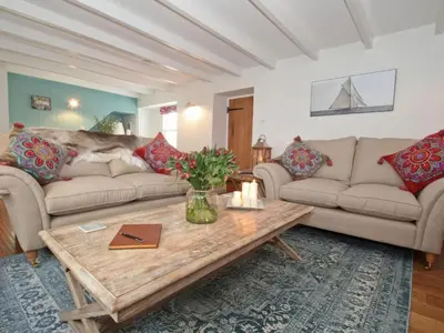 a living room with two couches and a coffee table at Trelan in St Austell