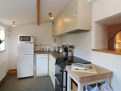 a kitchen with a stove and a refrigerator at Halvosso in Penryn
