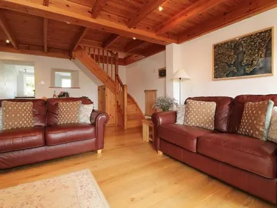a living room with two brown leather couches at Halvosso in Penryn