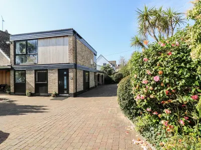 a brick driveway in front of a house at Little Beach House in St Austell