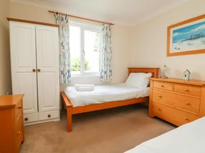 a bedroom with a bed and a window at Tre Pol Pen in Falmouth