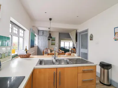 a kitchen with a sink and a counter at Little Trelawns in Mawgan Porth