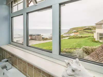 a window seat with a view of the ocean at Little Trelawns in Mawgan Porth