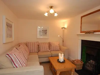 a living room with a couch and a fireplace at Jordan House in Boscastle