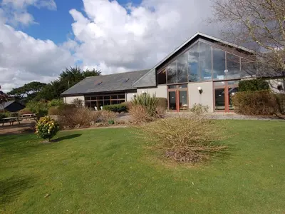 a large house with a large lawn in front of it at Pine Cottage in Falmouth
