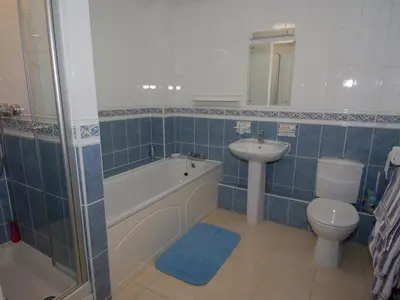a bathroom with a toilet and a sink and a bath tub and a toilet at Pine Cottage in Falmouth