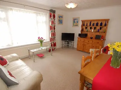 a living room with a couch and a table at Trevillas in St Austell