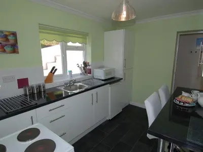 a kitchen with a sink and a counter top at Trevillas in St Austell