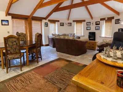 a living room with a table and a couch at Hideaway in Tintagel