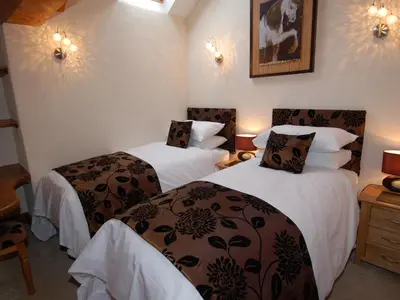 a hotel room with two beds with white and brown sheets at Hideaway in Tintagel