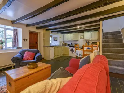 a living room with a couch and a table at Churchgate Cottage in Bodmin