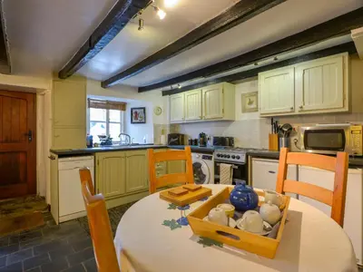 a kitchen with a table with a bowl on it at Churchgate Cottage in Bodmin