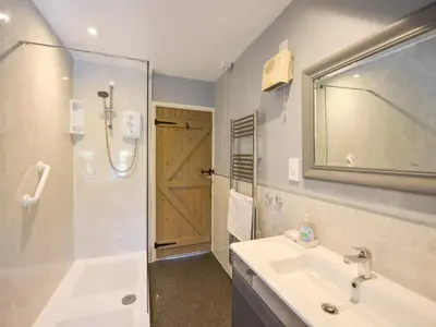 a bathroom with a sink and a shower at Churchgate Cottage in Bodmin