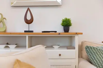 a living room with a table and a couch at Costentyn, Tor Down Quarry in Bodmin