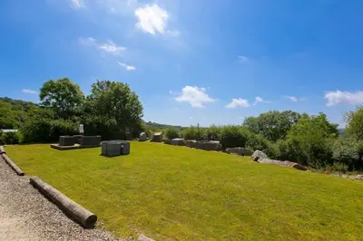 a grassy field with a bunch of objects on it at Costentyn, Tor Down Quarry in Bodmin