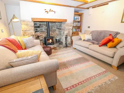 a living room with two couches and a fireplace at Blue Anchor in Saint Enoder