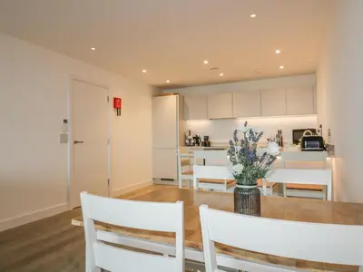 a kitchen and dining room with a table and chairs at Chapel Rock View, The Dunes in Perranporth