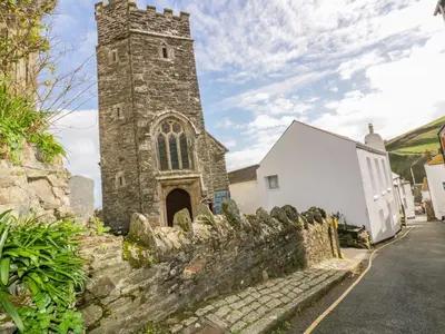 an old stone church with a tall tower at Brambles in Gorran Haven