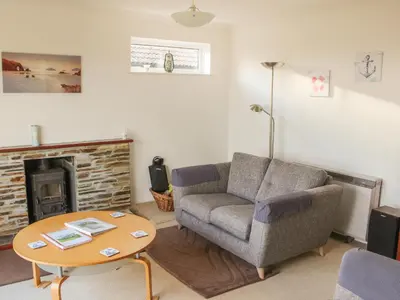 a living room with a couch and a coffee table at Brambles in Gorran Haven