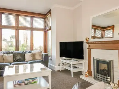 a living room with a couch and a fireplace at Chy-an-Brae in Newquay