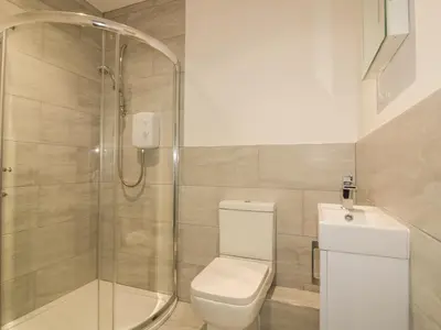 a bathroom with a shower and a toilet and a sink at Chy-an-Brae in Newquay