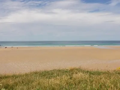 a beach with a lot of people on it at Little May in Newquay