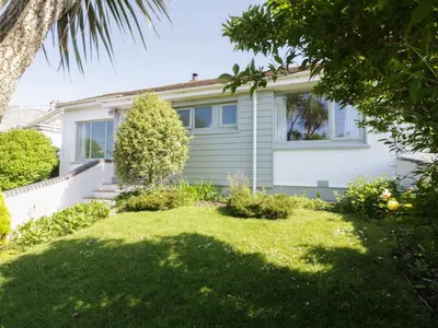 a house with a green lawn in front of it at Keelyn in Crantock