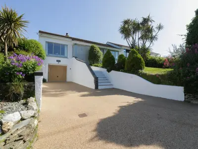 a white house with a gate and a driveway at Keelyn in Crantock
