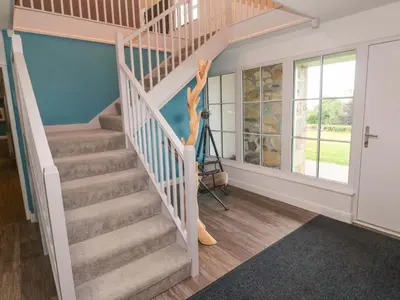 a staircase in a home with a stair case at Silvermine House in St Austell