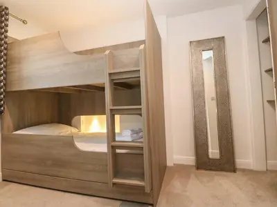 a bunk bed with a mirror in a room at Silvermine House in St Austell
