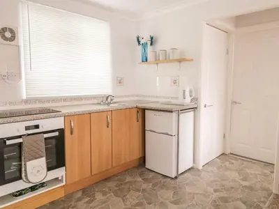a kitchen with a sink and a stove at Ducks Ditty in Liskeard