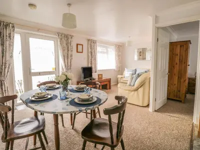 a living room with a table and chairs at Ducks Ditty in Liskeard