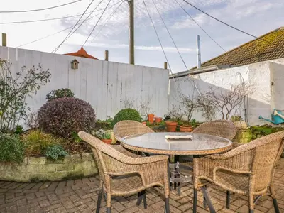 a patio with a table and four chairs at Bayview in St Austell