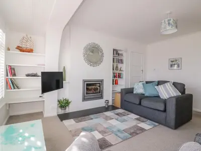 a living room with a couch and a tv at Bayview in St Austell