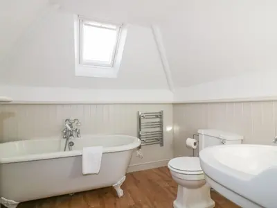 a bathroom with a tub and a toilet and a sink at Bayview in St Austell