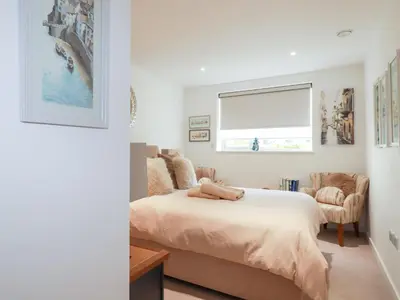 a bedroom with a bed and a window at Apartment no 21 in Newquay