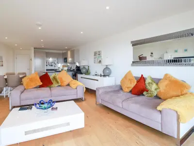 a living room with two couches and a table at Apartment no 21 in Newquay