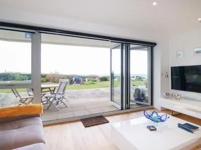 a living room with a large sliding glass door at Apartment no 21 in Newquay