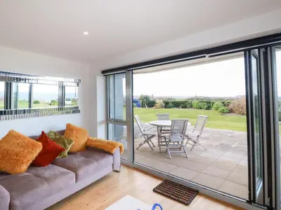 a living room with a couch and a patio at Apartment no 21 in Newquay