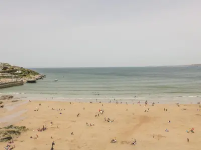 a group of people on a beach near the ocean at Onshore 7 in Newquay