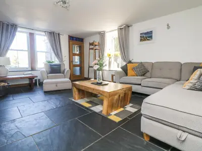 a living room with a couch and a coffee table at Miner's Rest in Camborne
