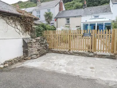 a wooden fence in front of a house at Pebble Cottage in Redruth