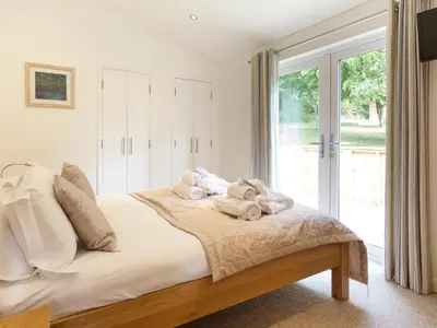 a bedroom with a bed with towels on it at 3 Valley View in Looe