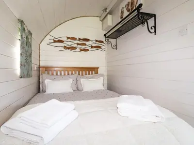 a bed in a room with two towels on it at The Lamb Shack in Bodmin