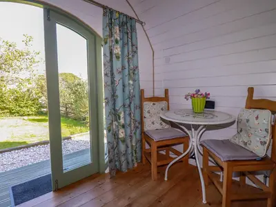 a room with a table and chairs and a window at The Lamb Shack in Bodmin