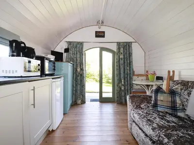 a living room with a couch and a table at The Lamb Shack in Bodmin