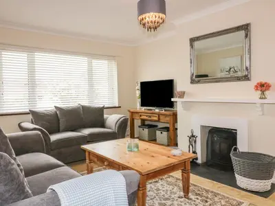 a living room with a couch and a fireplace at Dune Haven in Truro