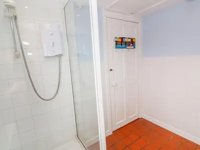 a shower with a glass door in a bathroom at Mount View Cottage in Marazion