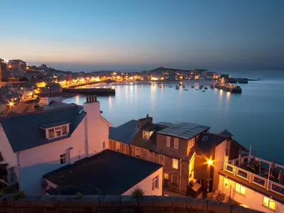 a view of a town with a harbor at night at The Lily Pad in Camborne